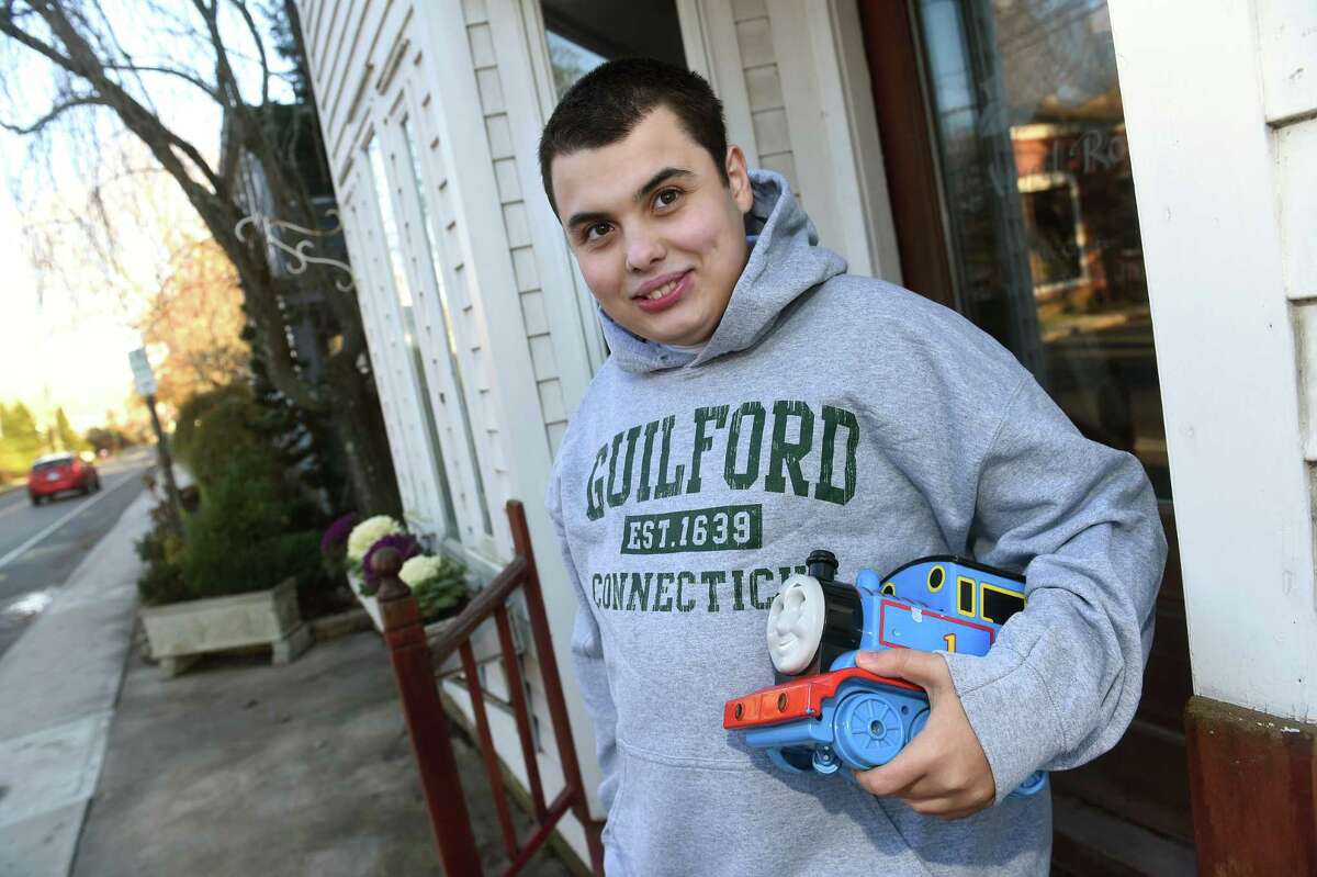 Gavin Toscano-Popick, 18, is photographed in front of the day center, Gavin & Friends, under construction on Boston Street in Guilford on December 1, 2022.