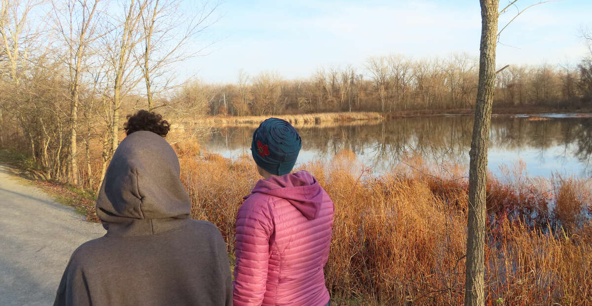 Gillian Scott, right, walks with her child through the Vischer Ferry Nature Preserve on a late fall afternoon.