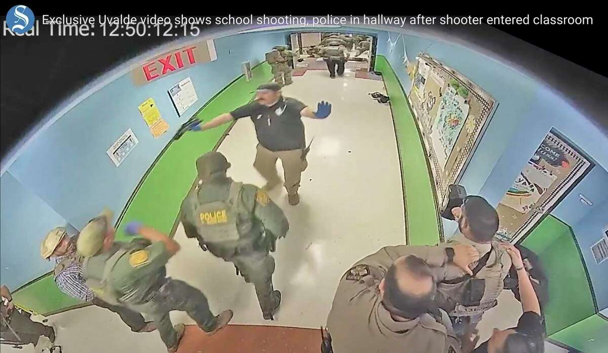 In this photo from surveillance video provided by the Uvalde Consolidated Independent School District, authorities respond to the shooting at Robb Elementary School in Uvalde, Texas, Tuesday, May 24, 2022. The city of Uvalde filed a lawsuit Thursday against District Attorney Christina Mitchell Busbee, alleging she has interfered with its investigation into the mass shooting. (Uvalde Consolidated Independent School District/Austin American-Statesman via AP, File)