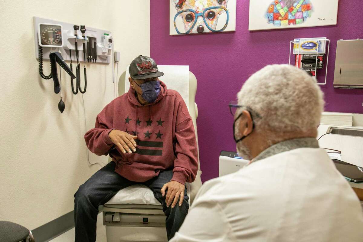 Dr. Tolbert Small, right, sees diligent  Ronald Young, left, astatine  Roots Community Health Center successful  Oakland, Calif., connected  Wednesday, Nov. 30, 2022.