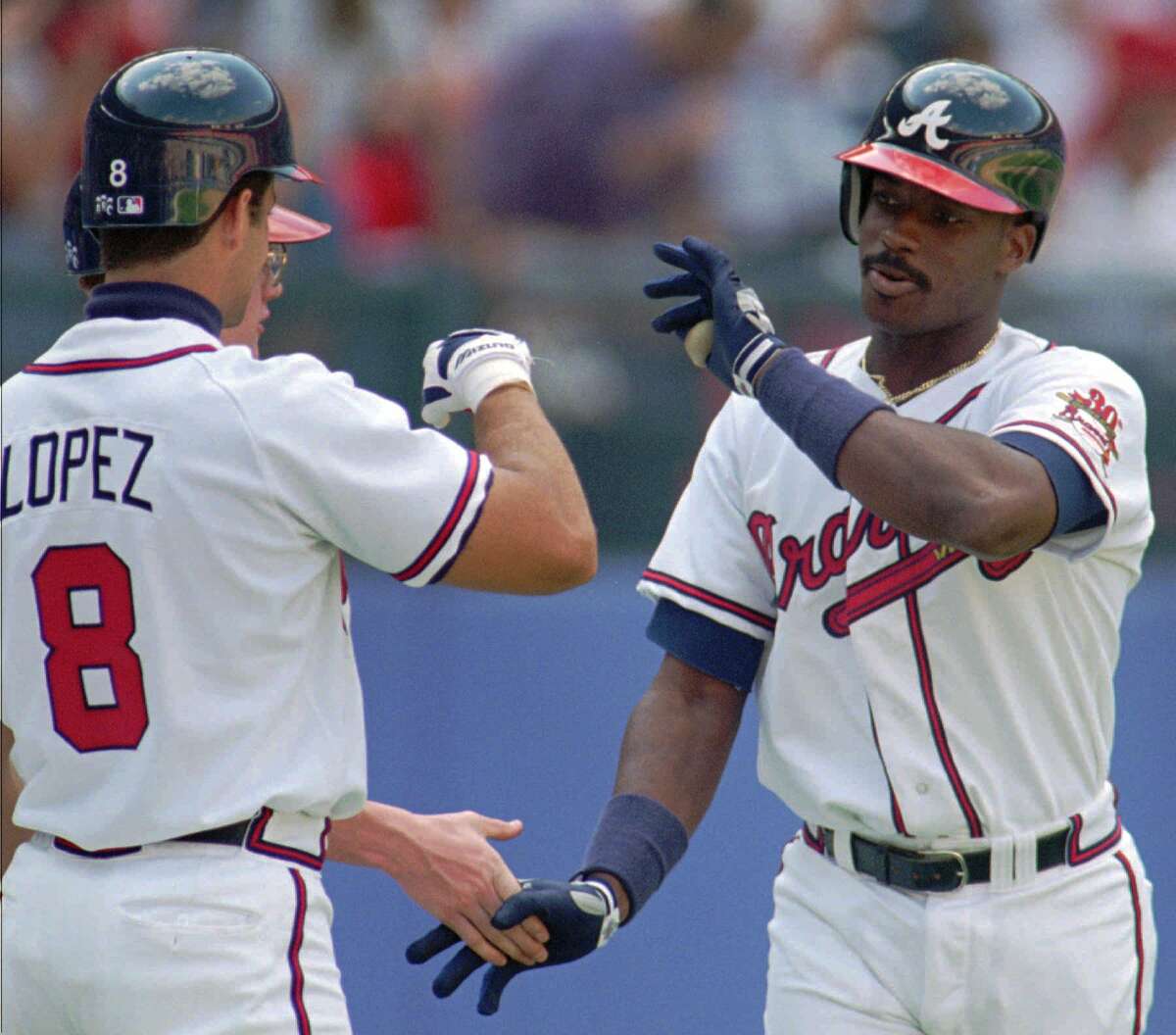 Atlanta Braves first baseman Fred McGriff, right, is congratulated by catcher Javier Lopez on his first homer of the season Wednesday, April 26, 1995 in Atlanta. The Braves defeated the San Francisco Giants 12-5 with McGriff getting two homers. (AP Photo/John Bazemore) ALSO Ran on: 07-29-2007 Fred McGriff went to the struggling Braves in a trade with the Padres in 1993 and helped his new team to a 104-win season. The 2007 Braves are looking hard at making a trade for the Rangers' Mark Teixeira. Ran on: 07-29-2007