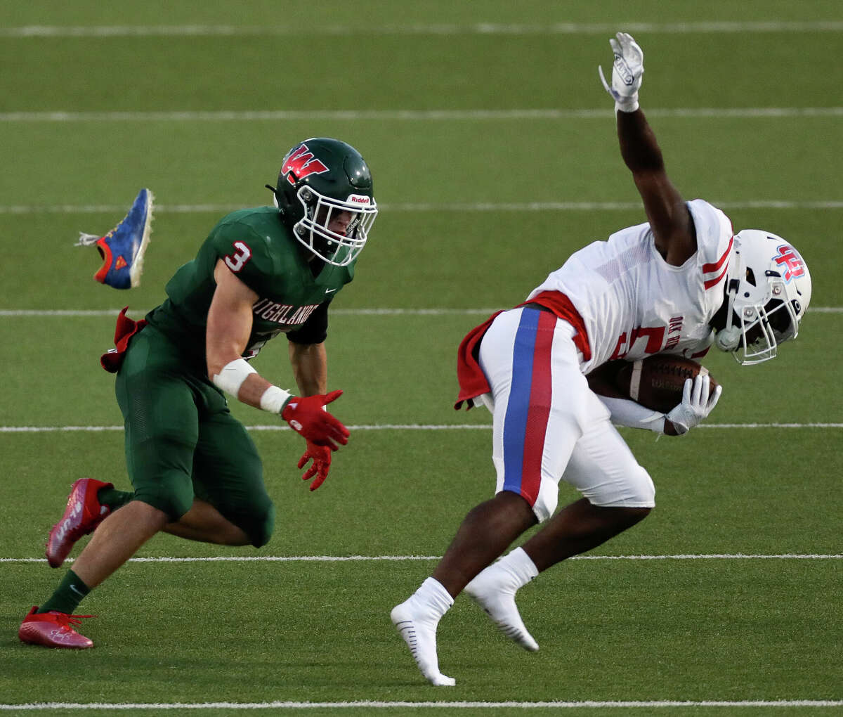 Oak Ridge running back Frankie Arthur (5) loses his shoe after breaking a tackle by The Woodlands linebacker JT Goff (12) in the second quarter of a District 13-6A high school football game at Woodforest Bank Stadium, Thursday, Sept. 8, 2022, in Shenandoah.