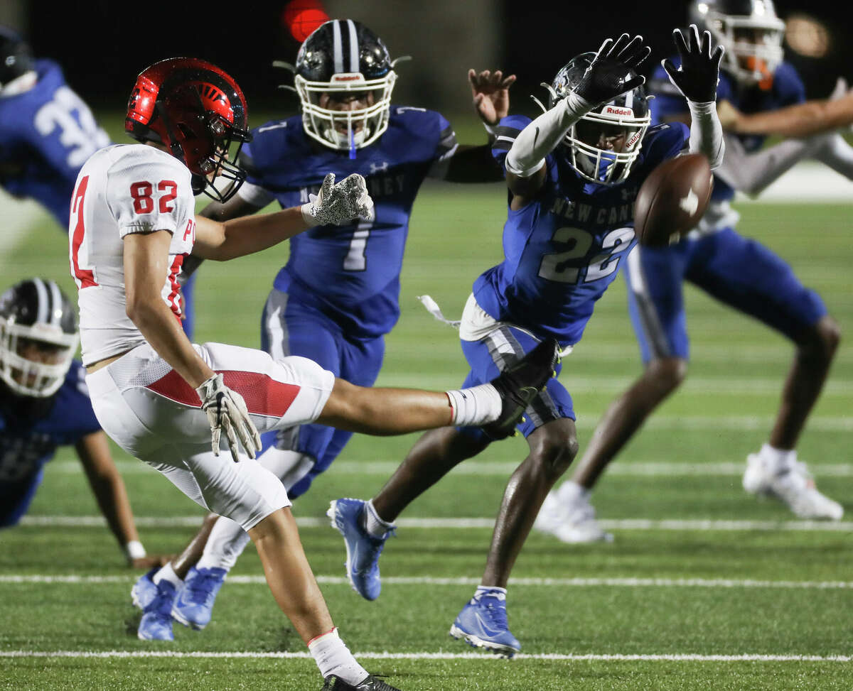 New Caney defensive back Chris Johnson (22) blocks a punt by Porter punter Alex Hernandez (82) in the second quarter of a non-district high school football game at Randall Reed Stadium, Friday, Sept. 2, 2022, in New Caney. New Caney linebacker Daylen Wilson recovered the block and returned it for a 25-yard touchdown.