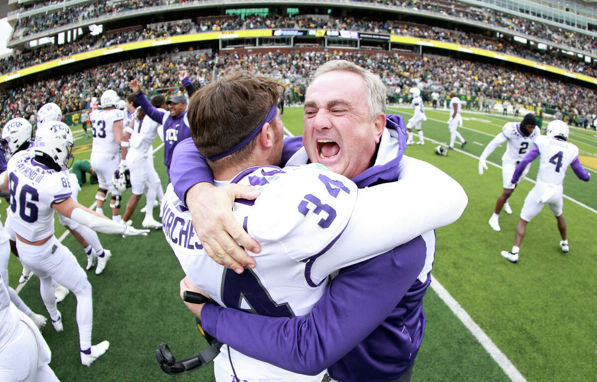 Head coach Sonny Dykes of the TCU Horned Frogs celebrates with linebacker Zach Marcheselli #34 of the TCU Horned Frogs after the Horned Frogs beat the Baylor Bears 29-28 at McLane Stadium on November 19, 2022 in Waco, Texas.