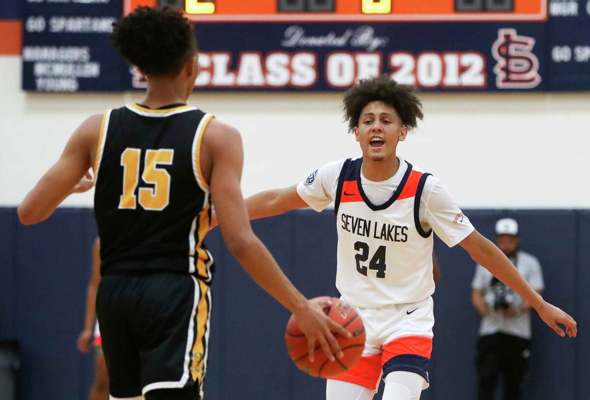 Seven Lakes guard AJ Bates (24) shouts out a set as Fort Bend Marshall guard Jaland Lowe (15) brings the ball up court in the first quarter of a non-district high school basketball game at Seven Lakes High School, Thursday, Dec. 1, 2022, in Katy.