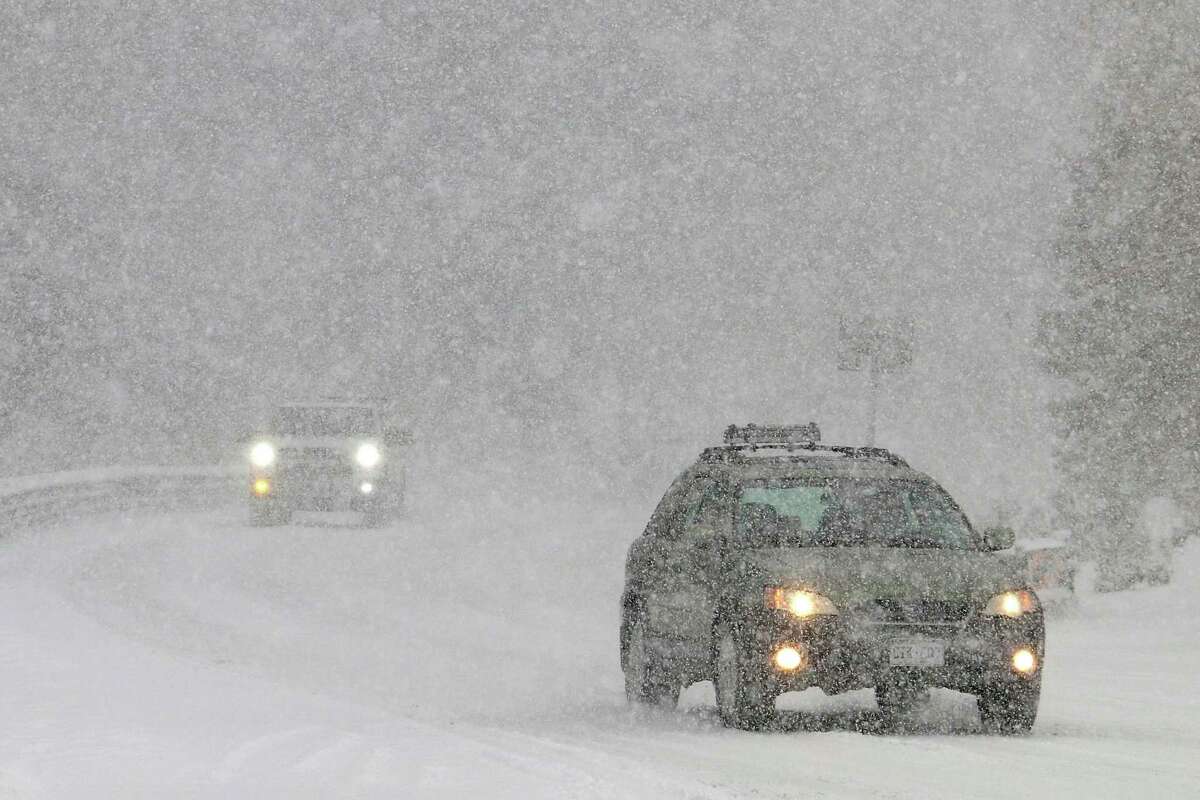 Cars slowly make their way as heavy snow falls on the Mount Rose Highway near Reno.