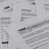 Various pages of the US IRS tax return forms with business tools