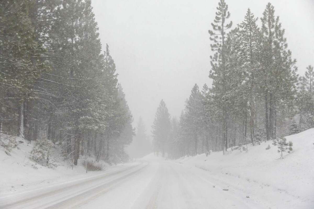 Snow falls on Hwy 50 heading towards South Lake Tahoe and the Meyers chain controls.