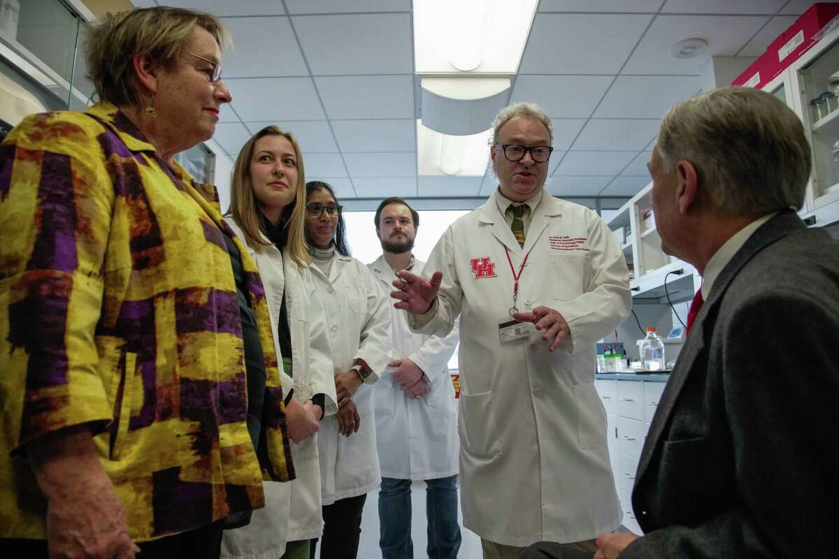Research Associate Professor at University of Houston, Dr. Colin N. Haile speaks to Governor Greg Abbott while on a tour of the University of Houston fentanyl vaccine lab on Thursday, Dec. 1, 2022.