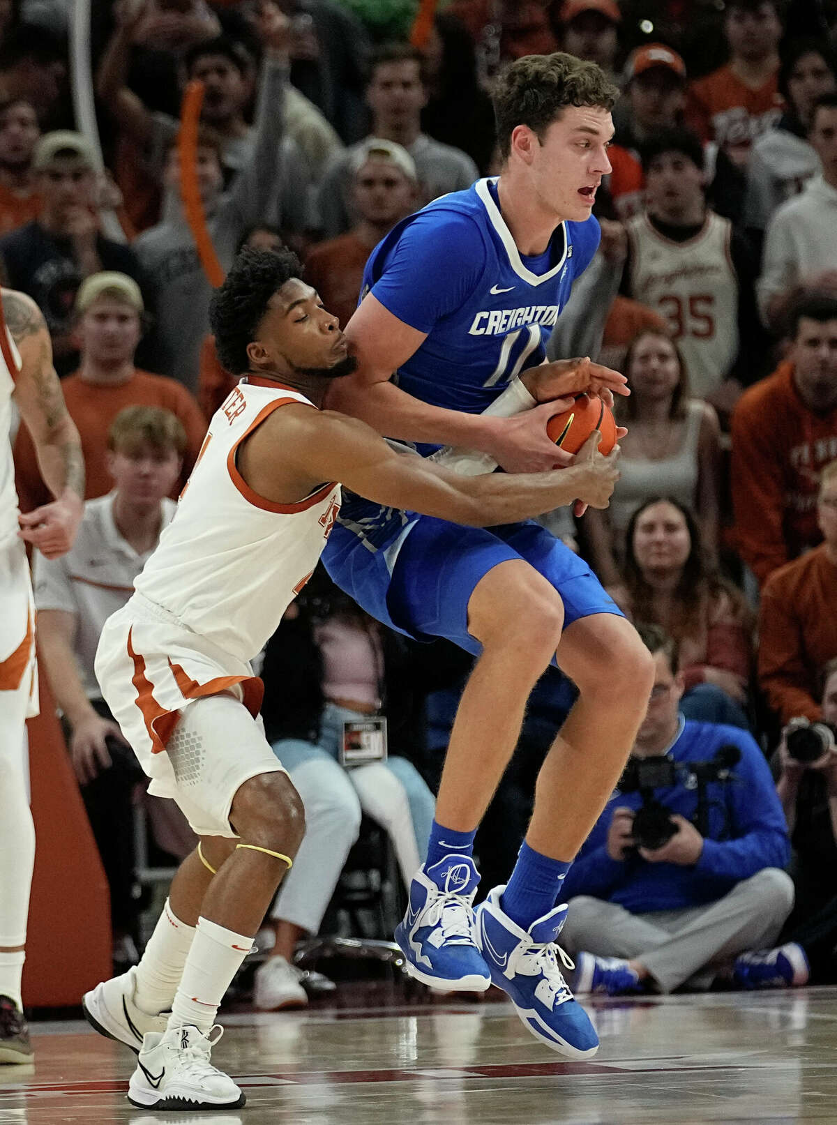Creighton center Ryan Kalkbrenner (11) tries to keep the ball from Texas guard Tyrese Hunter during the second half of an NCAA college basketball game in Austin, Texas, Thursday, Dec. 1, 2022. (AP Photo/Eric Gay)