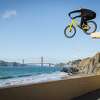 MacAskill jumps off a ledge down to a ramp on China Beach.