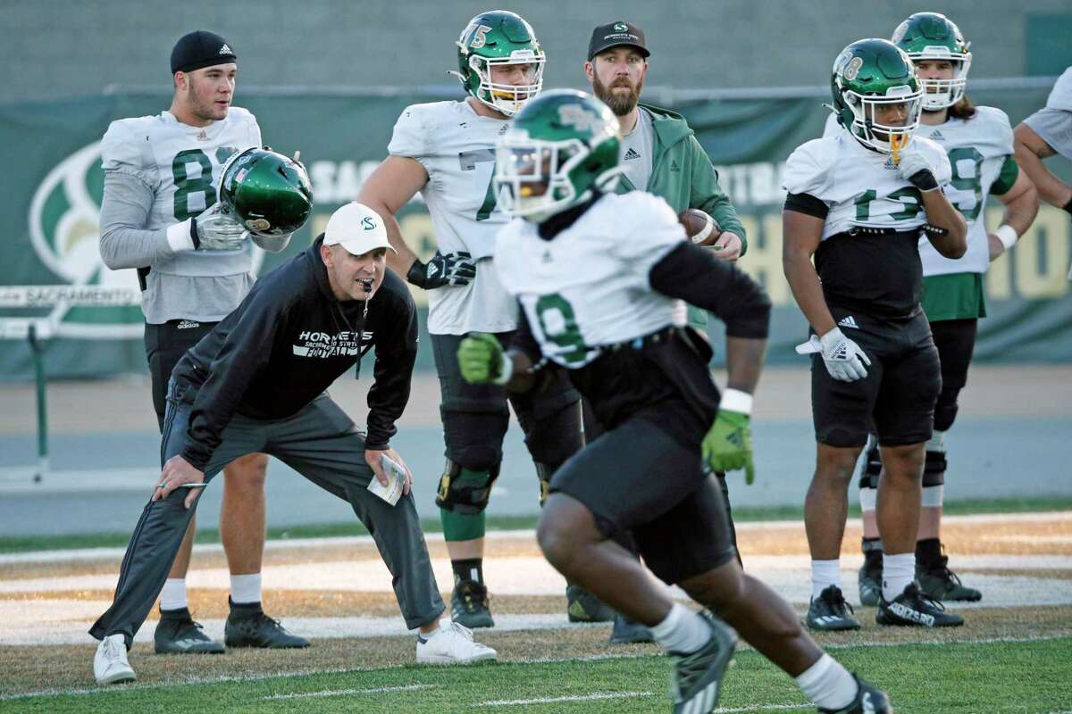 Sacramento State Hornets head coach Troy Taylor (second from left) during football practice at Hornet Stadium in Sacramento on Tuesday, Nov. 29, 2022.