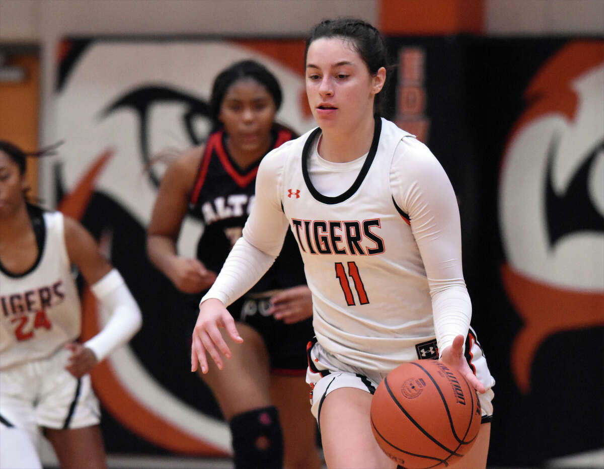 Edwardsville's Kaitlyn Morningstar brings the ball up the court against Alton in Southwestern Conference action inside Lucco-Jackson Gymnasium in Edwardsville.