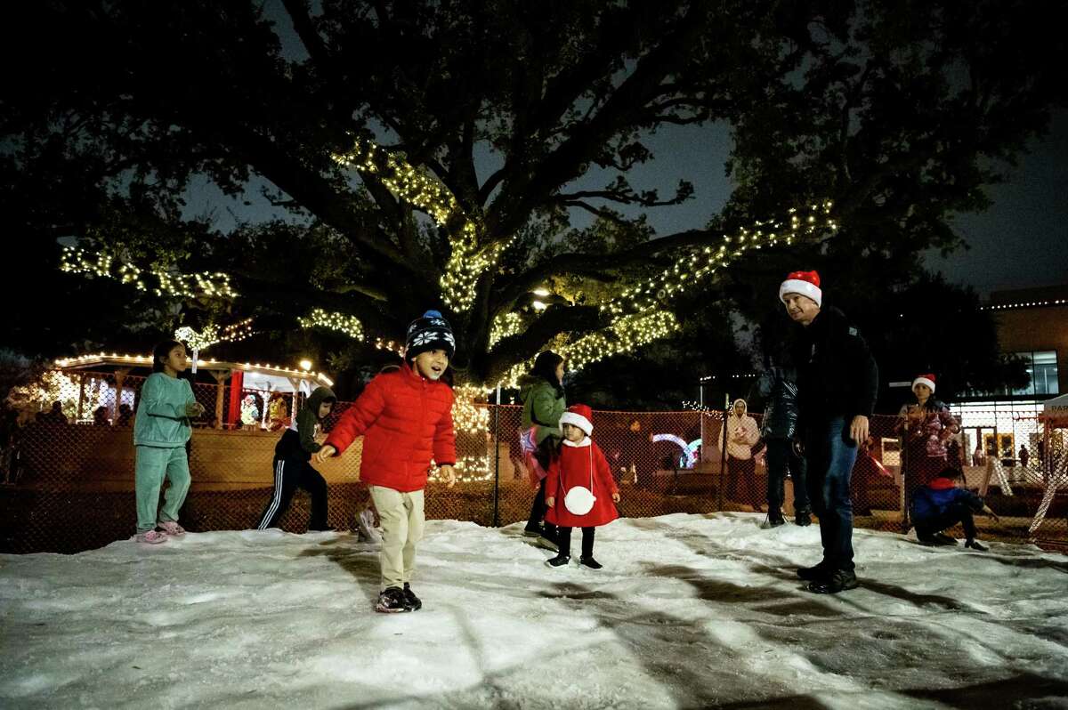 Families enjoy playing in snow at The City of Bellaire’s ‘Holiday in the Park’ event on Thursday, December 1, 2022 in Houston, Texas.