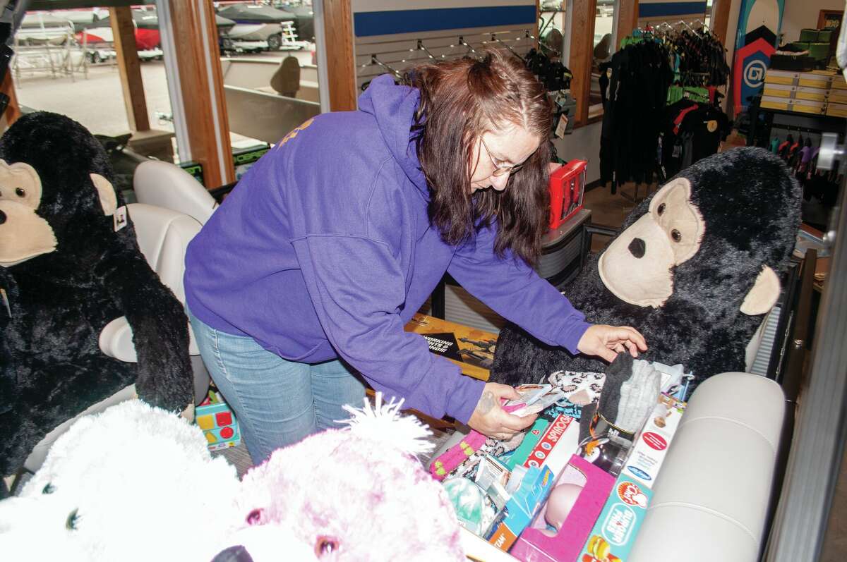 Mecosta County Toys for Tots coordinator Angela Malek organizes toys on a pontoon boat Friday at Lakeside Motor Sports in Mecosta. The toys were recently donated to ensure that children have toys for Christmas. 