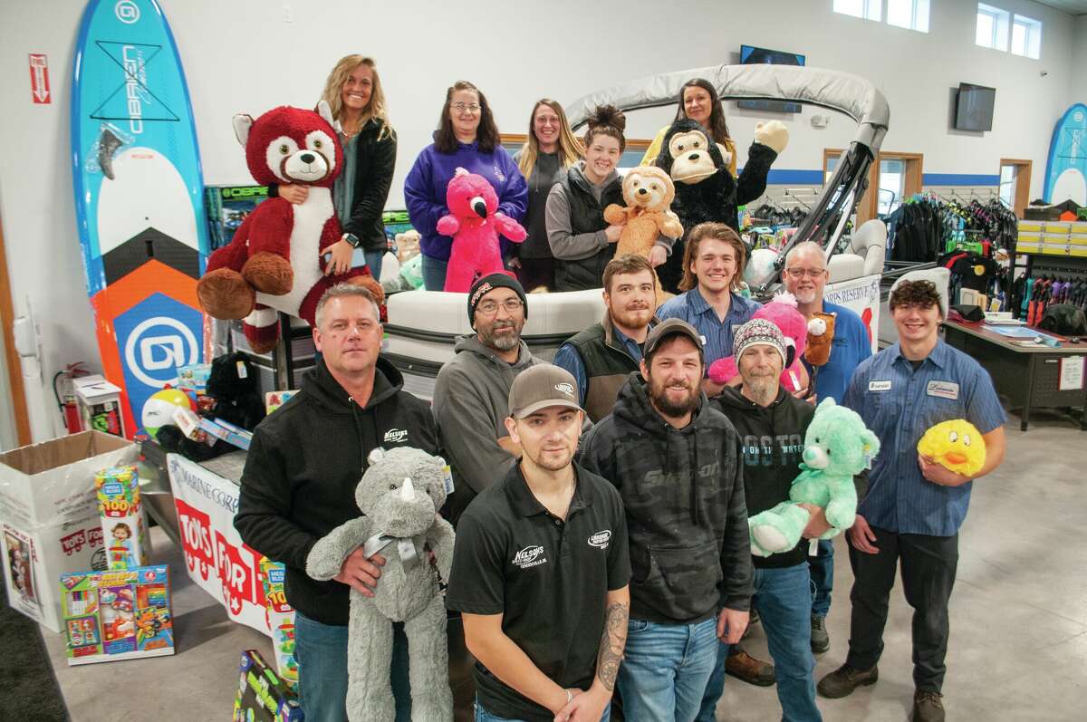 The staff of Lakeside Motor Sports, 10964 90th Ave. in Mecosta, stand in front of a pontoon boat that was recently filled with toys for the Mecosta County Toys for Tots program. 