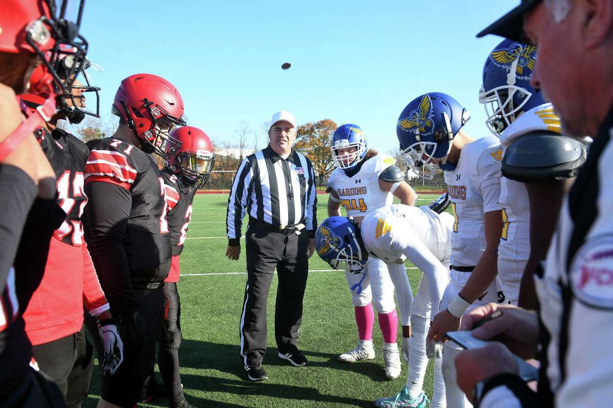 A referee flips the coin prior to kickoff of the annual Thanksgiving Day game between Central and Harding High School, at Kennedy Stadium, in Bridgeport, last month.