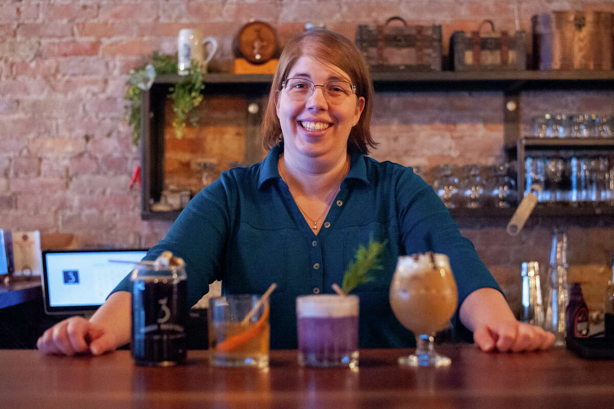 Daily News reporter Victoria Ritter poses with alcoholic drinks on Nov. 30 at Three Bridges Distillery.