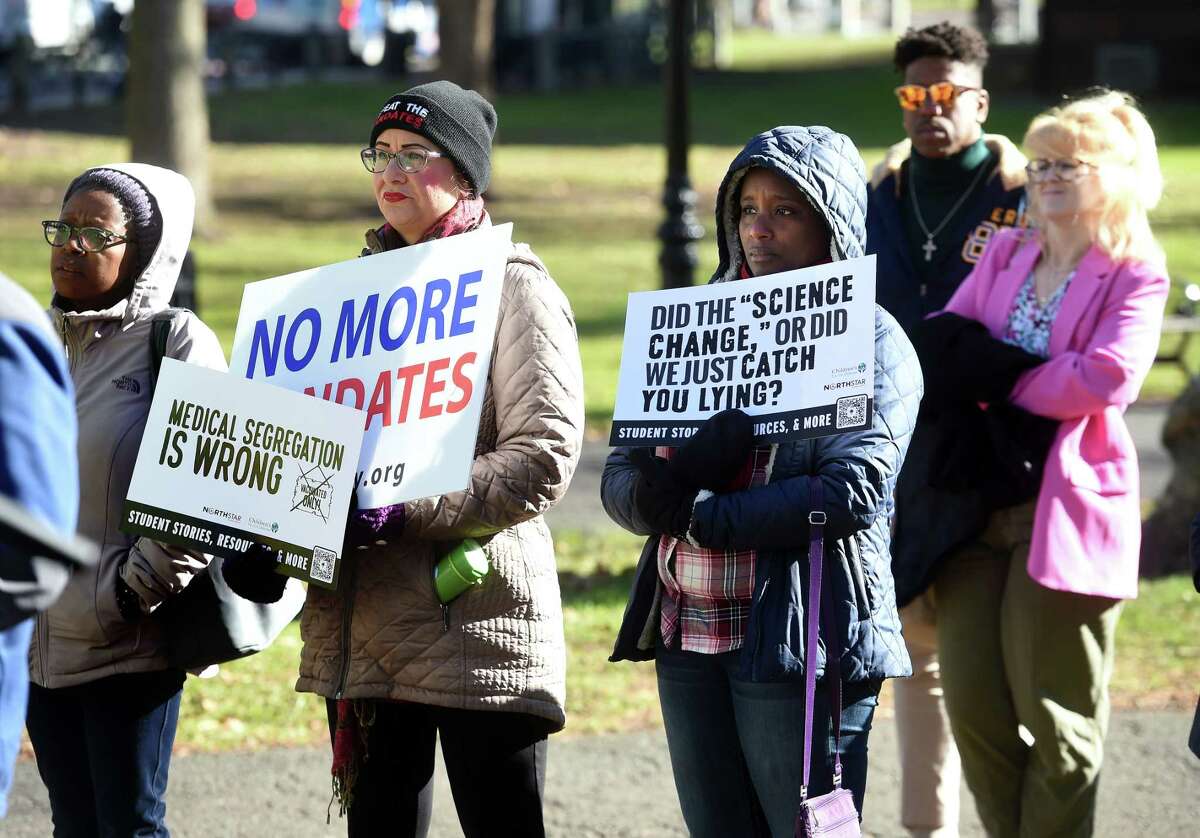 People listen to former UCONN student Phoebe Liou speak at a rally on the New Haven Green on December 2, 2022 in opposition to a Yale University mandate for students to get a bivalent COVID-19 vaccine booster shot by January 31, 2023.