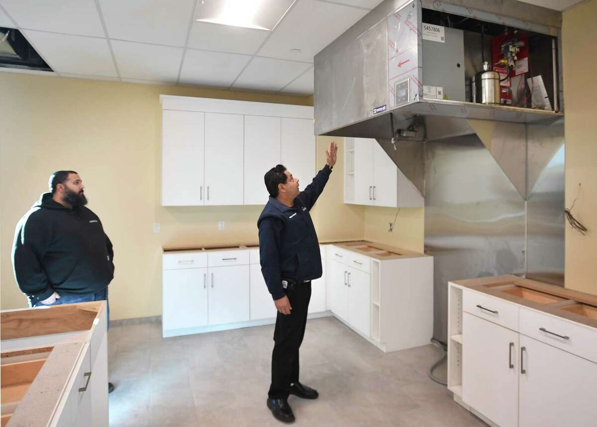 Project Manager Paul Sekas, left, and Ansonia Mayor David Cassetti, check out the new high tech range hood installed in the kitchen of the nearly completed new Ansonia Senior Center in the Ansonia Police Station building at 65 Main Street in Ansonia, Conn. on Friday, Dec. 2, 2022.
