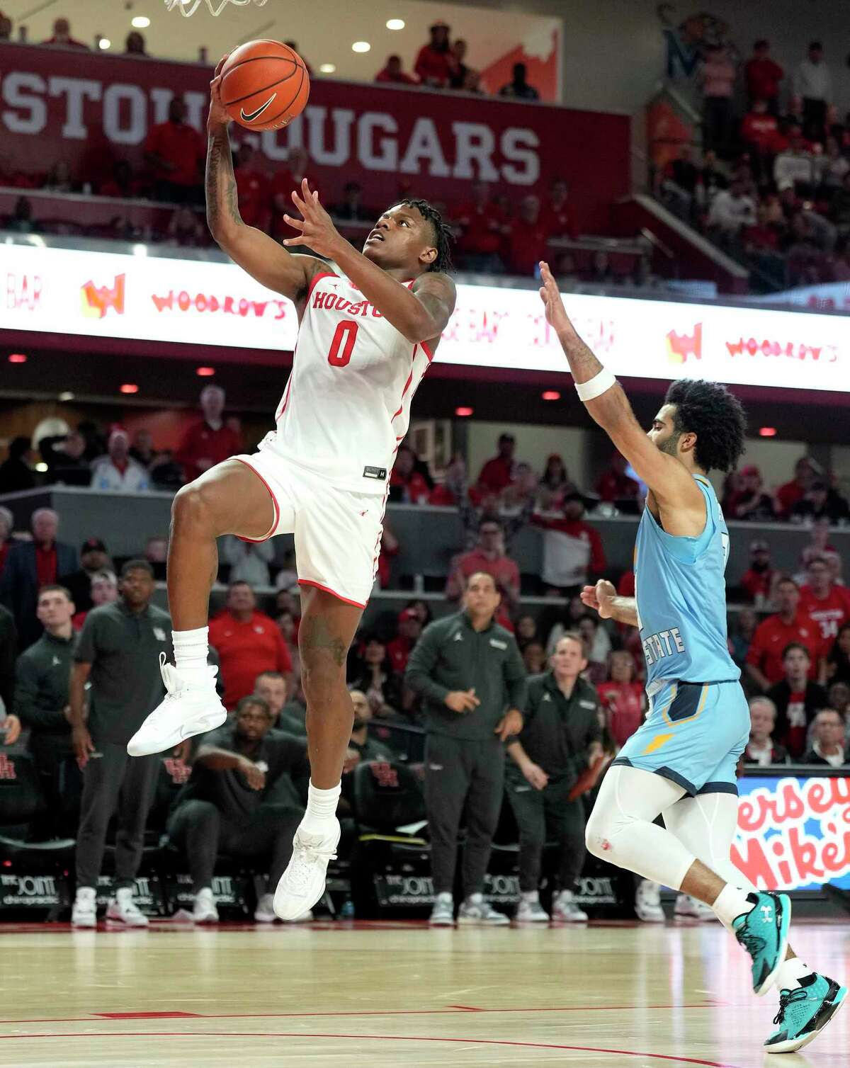 Houston Cougars guard Marcus Sasser (0) goes to the basket against Kent State Golden Flashes guard Sincere Carry (3) during the second half of an NCAA men’s base basketball game at Fertitta Center on Saturday, Nov. 26, 2022 in Houston.