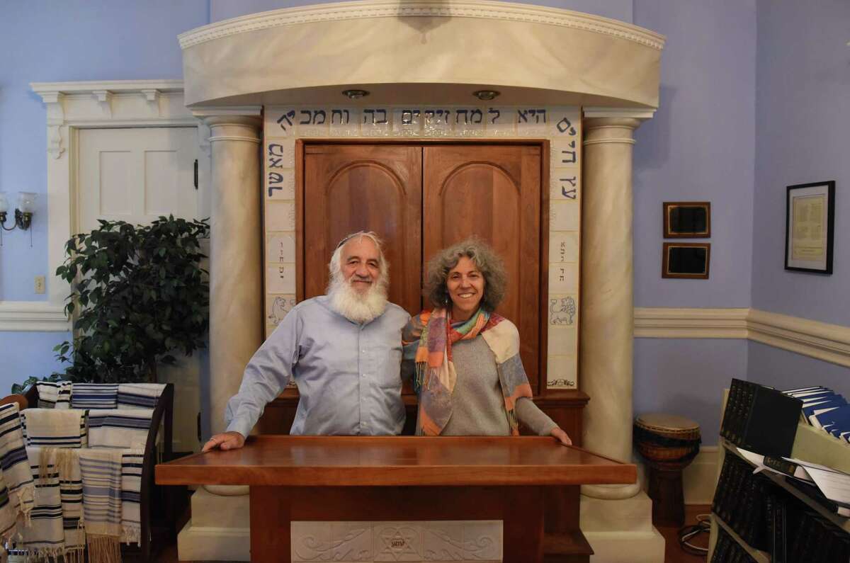 Temple Sinai husband and wife co-rabbis Jonathan Rubenstein and Linda Motzkin stand for a photo on Friday, Dec. 2, 2022, at Temple Sinai in Saratoga Springs, N.Y.