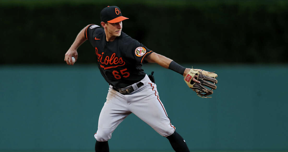 Rylan Bannon #65 of the Baltimore Orioles throws the ball to first base for an out in the fourth inning at Comerica Park on May 13, 2022 in Detroit, Michigan. (Photo by Mike Mulholland/Getty Images)