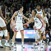 Connecticut's Azzi Fudd (35) congratulates teammate Lou Lopez-Senechal (11) after Lopez-Senechal hit a basket at the end of the first half of an NCAA college basketball game against Providence, Friday, Dec. 2, 2022, in Storrs, Conn. (AP Photo/Jessica Hill)