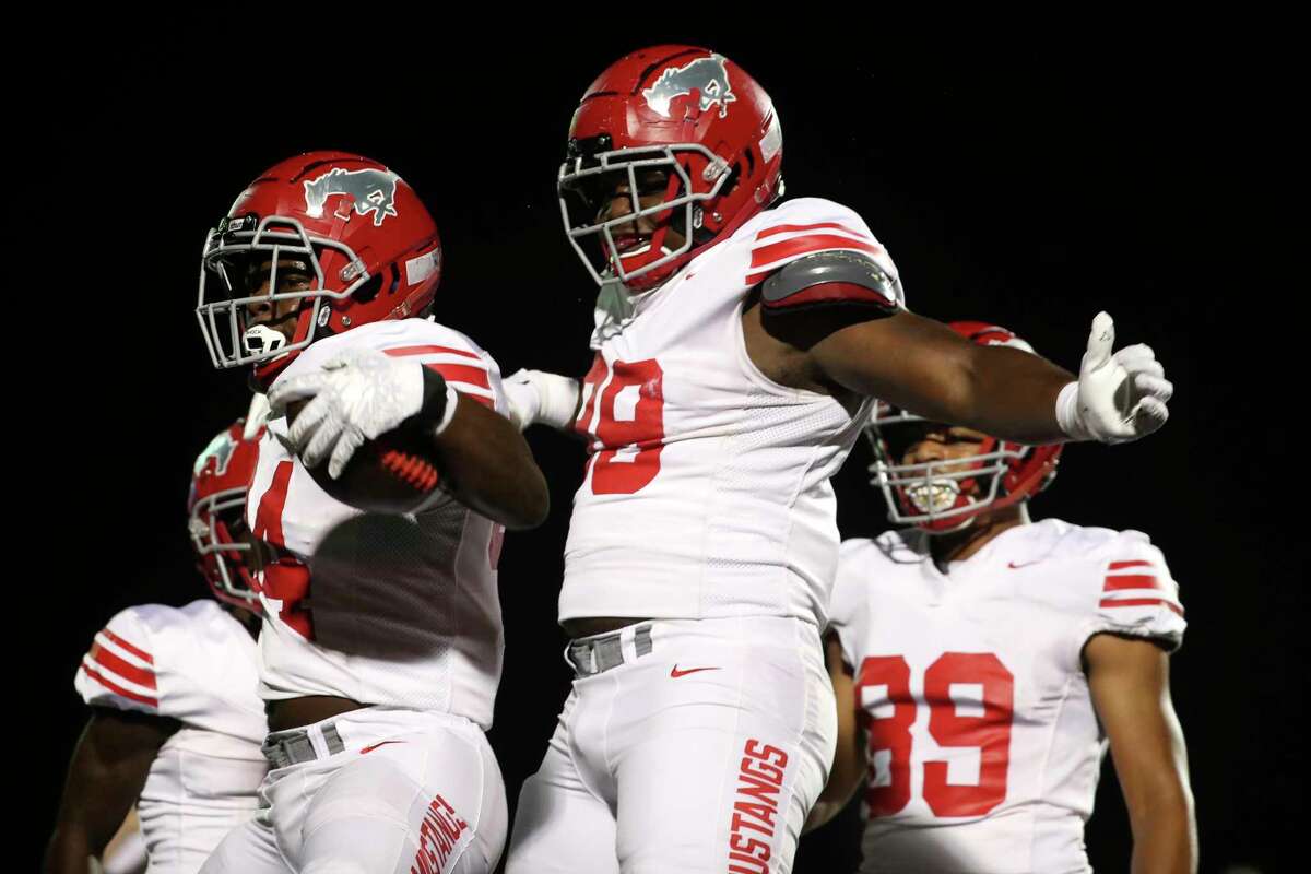 North Shore running back Rashaad Johnson (34) reacts after running for an 8-yard touchdown in the first quarter of a Region III-6A Division I state quarterfinal game at Randall Reed Stadium, Friday, Dec. 2, 2022, in New Caney.