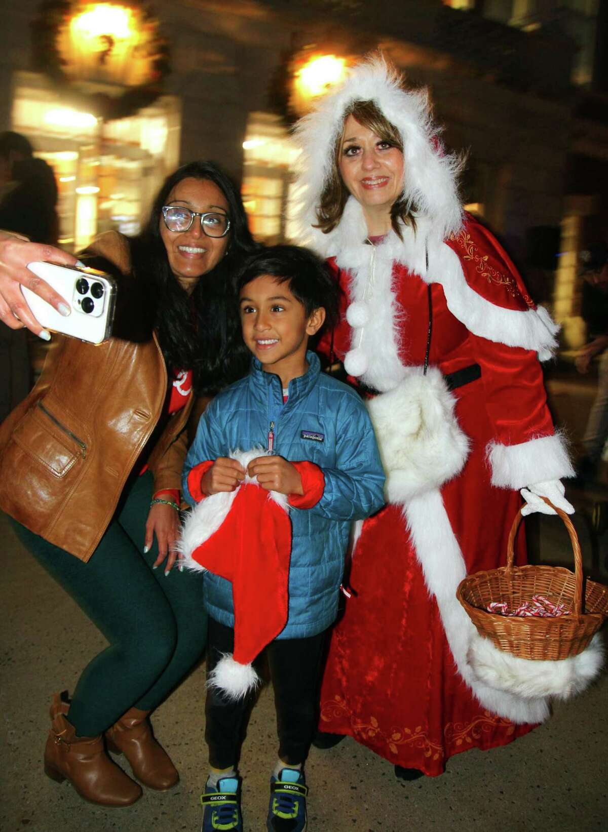 Sowmya Gadey takes a selfie of her son Aiden, 6, with Mrs. Claus during Greenwich's annual tree lighting in front of Town Hall in Greenwich, Conn., on Friday December 2, 2022. Entertainment was provided by Greenwich a cappella and Allegra Dance Greenwich. Families came out to enjoy Christmas music, live choirs and kids got a chance to meet Santa, Mrs. Claus as well as Frosty the Snowman and Rudolph the Red-Nosed Reindeer.