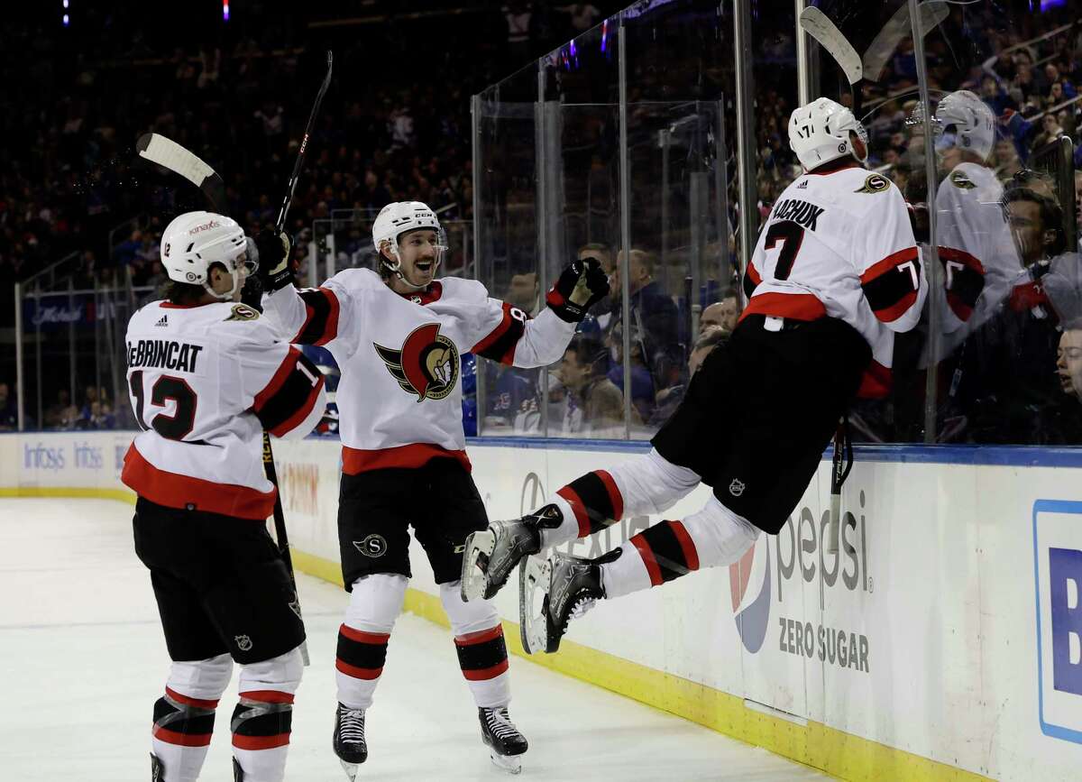 NEW YORK, NEW YORK - DECEMBER 02: Brady Tkachuk #7 of the Ottawa Senators celebrates his game-tying goal goal with teammates Jake Sanderson #85 and Alex DeBrincat #12 during the last minute of the third period against the New York Rangers at Madison Square Garden on December 02, 2022 in New York City. (Photo by Jim McIsaac/Getty Images)