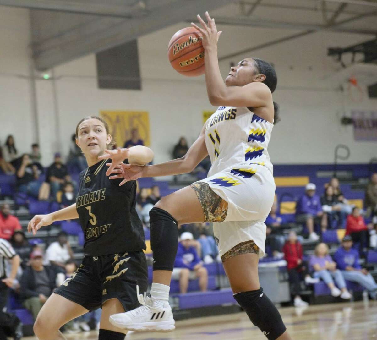 Midland High's Tyleah Taylor goes up for a layup while being defended by Abilene High's Samia Cooper during a Dec. 2 basketball game at the MHS gym. 