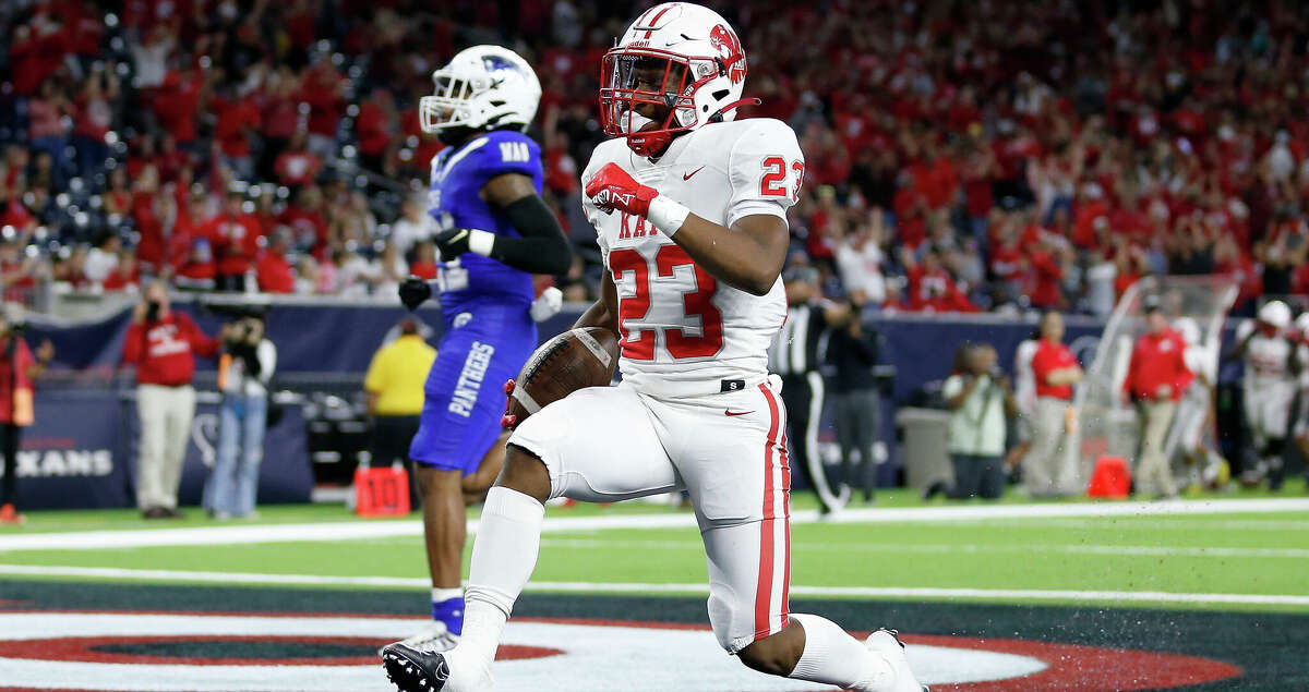 Katy Tigers running back Seth Davis (23) rushes for a touchdown in front of C. E. King Panthers Logan Mackey (21) during the high school football playoff game between the C. E. King Panthers and the Katy Tigers at NRG Stadium in Houston, TX on Friday, December 2, 2022. Katy leads C. E. King 28-27 at halftime.