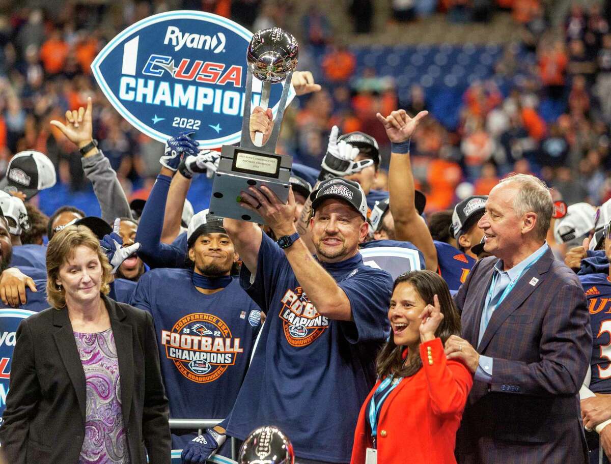 UTSA Coach Jeff Taylor holds up the C-USA championship trophy Friday night, Dec. 2, 2022 at the Alamodome after the Roadrunners beat the North Texas Mean Green 48-27 to win back-to-back championships.