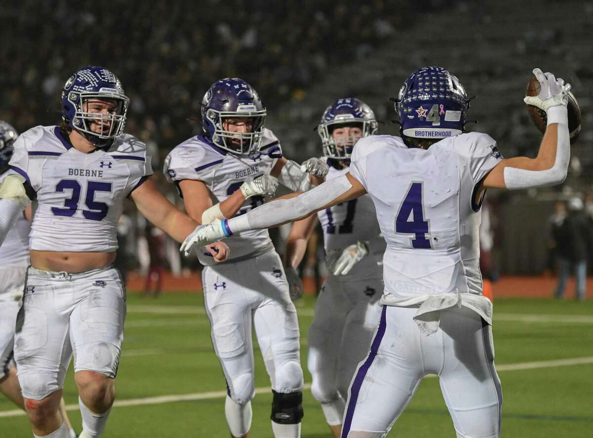 Boerne defensive back Koen Wolff celebrates with teammates after scoring on a pass interception during the UIL Class 4A Division I State Quarterfinal playoff game against Calallen at Alamo Stadium on Friday, Dec. 2, 2022. Boerne defeated Calallen, 49-19.
