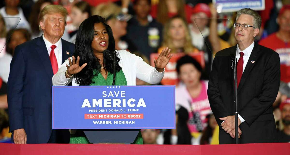 FILE - Former President Donald Trump, left, and Michigan Republican attorney general candidate Matt DePerno, right, listen as Michigan Republican secretary of state candidate Kristina Karamo addresses the crowd during a rally at the Macomb Community College Sports & Expo Center in Warren, Mich., Saturday, Oct. 1, 2022. Karamo, a community college instructor, ran as a far-right candidate in the 2022 midterms after becoming one of the most prominent election conspiracists in the country. (Todd McInturf/Detroit News via AP, File)