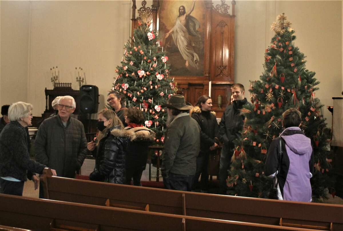 Visitors to the Old Kirke Museum in Manistee look at Christmas trees decorated in the traditional Danish, Swedish and Norwegian manner Saturday.