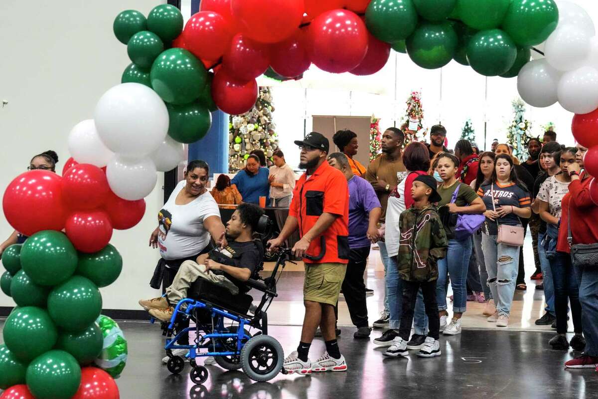 People file in to the inaugural City Wide “Special Needs” Day at the George R. Brown Convention Center on Saturday, Dec. 3, 2022 in Houston. More than 1,200 Houstonians participated in the event, organized by rapper and philanthropist Trae tha Truth, that featured games, music, face painting and rides for people of all ages.