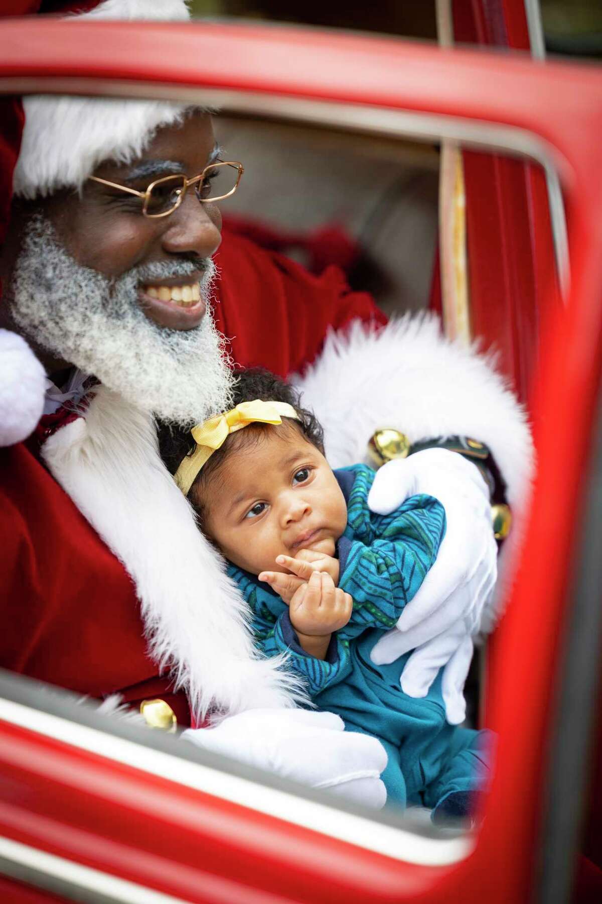 Black Santa Houston has storytime with children in Third Ward