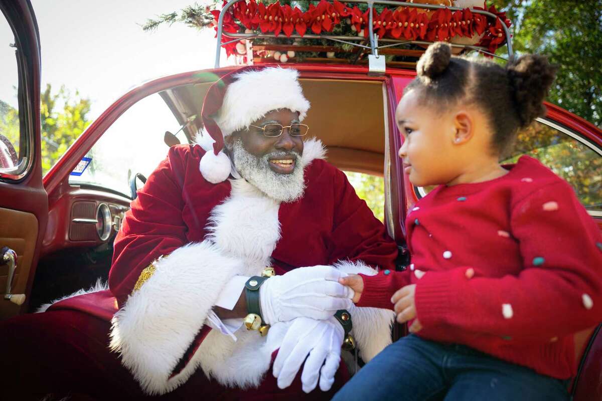 Black Santa Houston has storytime with children in Third Ward