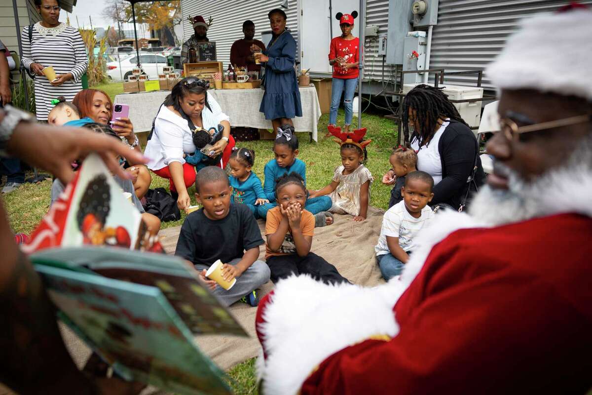 Children listen during a Storytime with Santa event on Saturday, Dec. 3, 2022 at Kindred Stories in Houston.