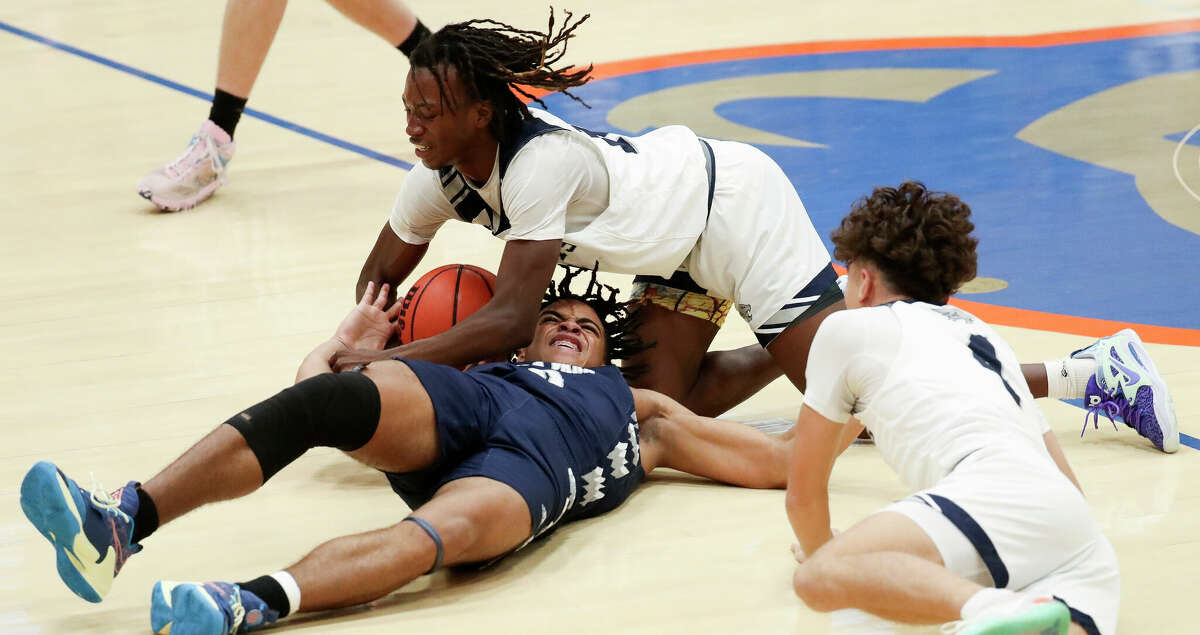 College Park guard Drake Kelley (10) fights for a loose ball against Tomball Memorial shooting guard Cory O'Bryant (11) in the third quarter of a non-district high school basketball game at Grand Oaks High School, Saturday, Dec. 3, 2022, in Spring.