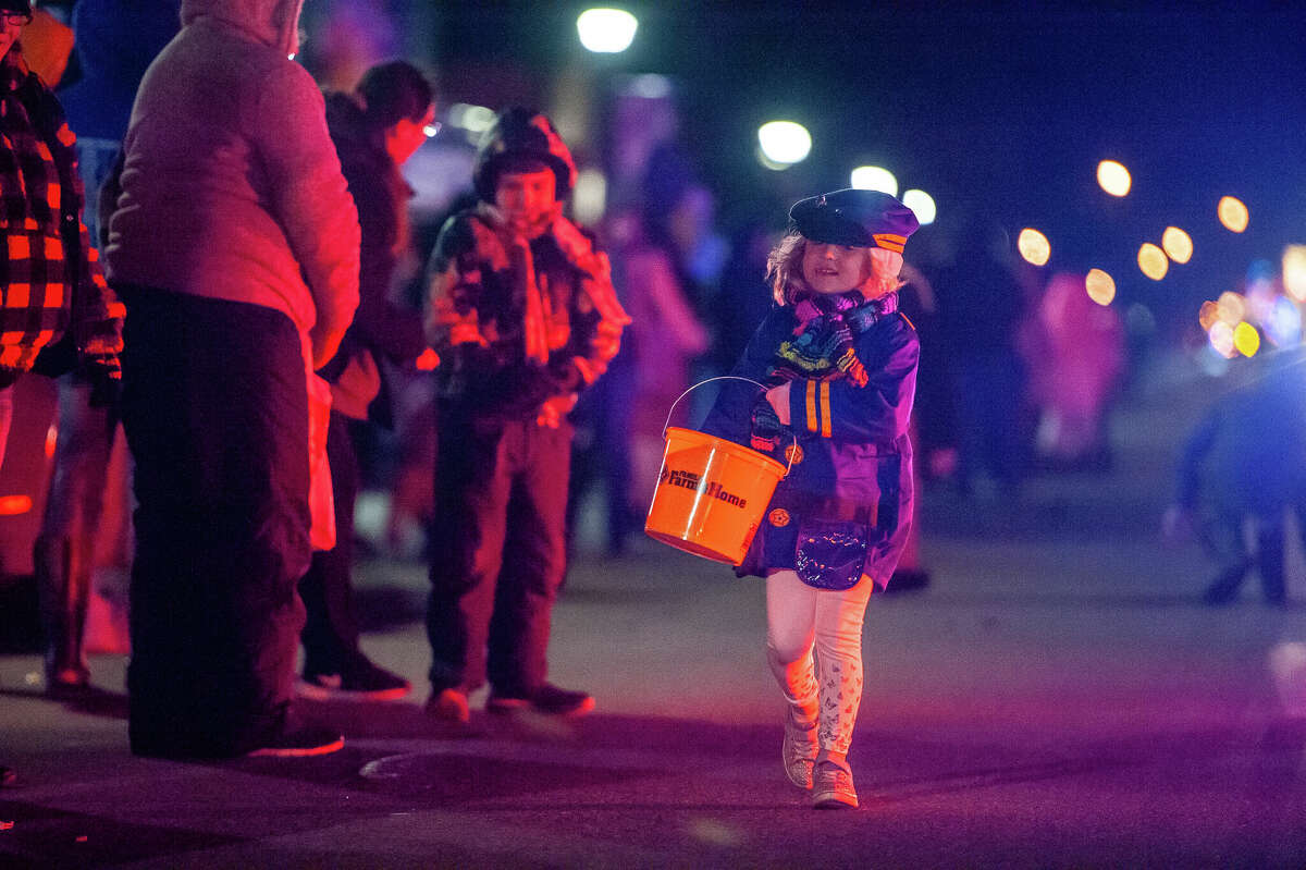 Midland resident Josey Stanford, 4, passes out candy at the Gladwin County Festival of Lights Christmas Parade on Dec. 3, 2022 in Gladwin.