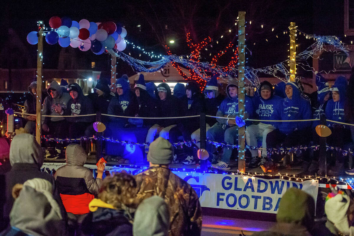 The Gladwin High School football team waves to the crowd at the Gladwin County Festival of Lights Christmas Parade on Dec. 3, 2022 in Gladwin. The Flying G's recently won a football state championship.