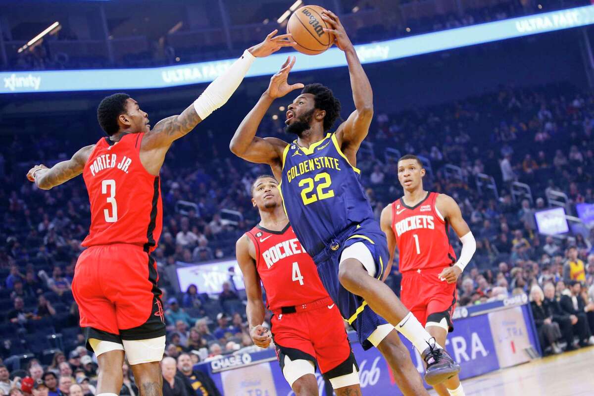 Golden State Warriors forward Andrew Wiggins (22) against Houston Rockets guard Kevin Porter Jr. (3) in the first quarter of an NBA game at Chase Center in San Francisco, Calif., Saturday, Dec. 3, 2022.