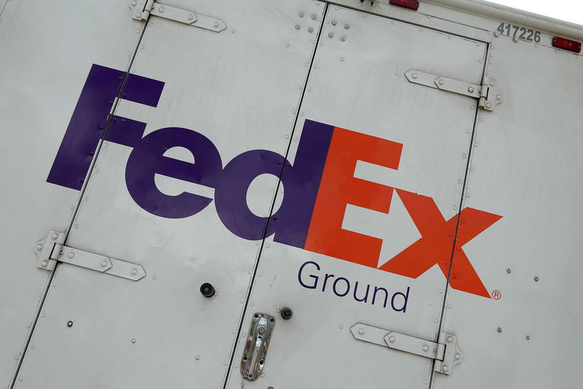 FILE PHOTO A sign on the side of a FedEx truck.
