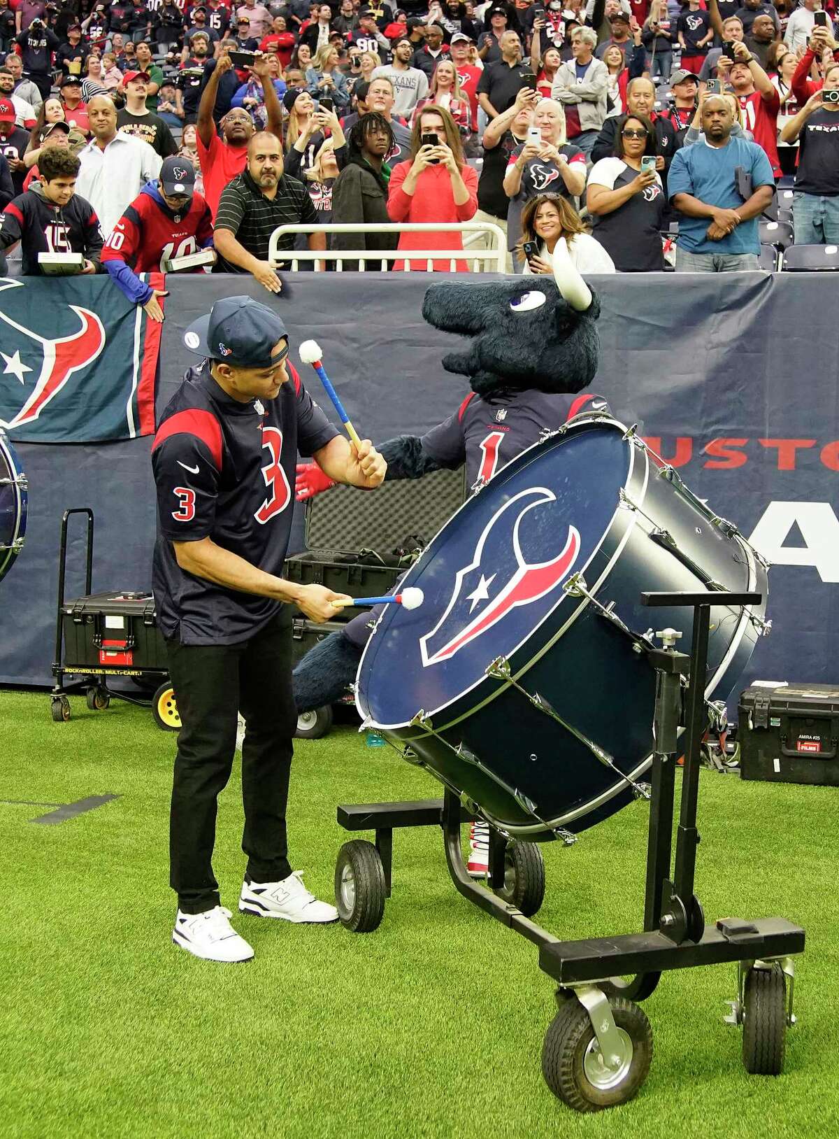 Houston Astros shortstop Jeremy Peña plays a drum with Blue Steel before the start of the first quarter of an NFL football game at NRG Stadium on Sunday, Dec. 4, 2022 inHouston .