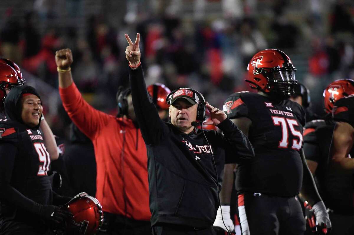 Texas Tech head coach Joey McGuire signals players against Kansas during the second half of an NCAA college football game Saturday, Nov. 12, 2022, in Lubbock, Texas. (AP Photo/Justin Rex)
