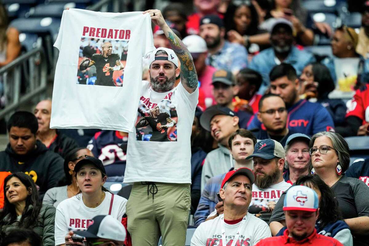 A Houston Texans fan holds up a shirt derogatory toward Cleveland Browns quarterback Deshaun Watson during the first half an NFL football game Sunday, Dec. 4, 2022, in Houston.