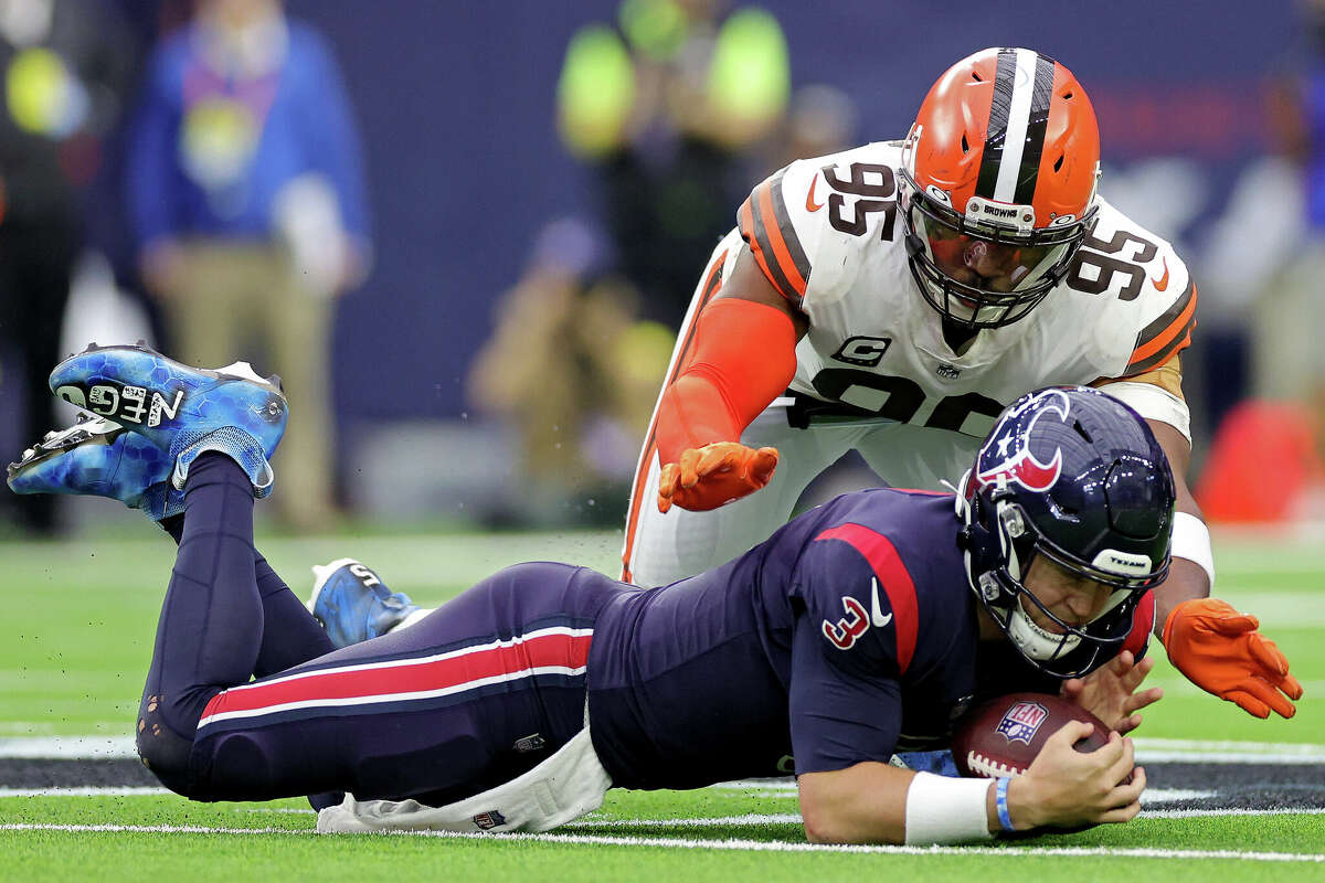 Kyle Allen #3 of the Houston Texans recovers a fumble in front of Myles Garrett #95 of the Cleveland Browns during the second quarter at NRG Stadium on December 04, 2022 in Houston.